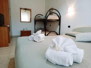 a hotel room with two beds with towels on them at RESIDENCE CERRA in Otranto
