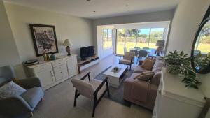 una sala de estar con un sofá y sillas en Apartment Miraflores, en Mijas Costa