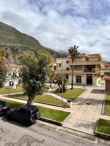 a car parked in a parking lot in front of a building at B&B Dora 2,0 in Praia a Mare