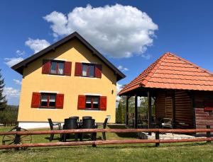 a house with a gazebo in front of it at Tarska Vila - Vera in Kaludjerske Bare