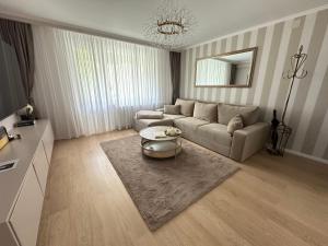 a living room with a couch and a table at Sovata Apartment in Sovata
