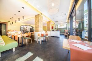 restaurację ze stołami i krzesłami oraz kawiarnię w obiekcie Le Clervaux Boutique Hotel & Spa w mieście Clervaux