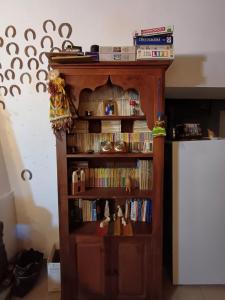 a book shelf filled with books and dvds at La Arcadia in Tafí del Valle