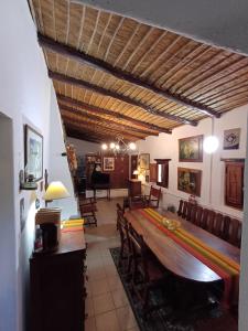 a dining room with a large wooden table and chairs at La Arcadia in Tafí del Valle