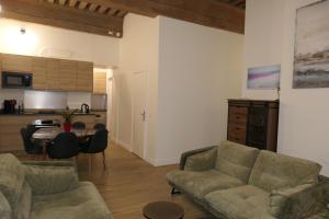 a living room with a couch and a table and a kitchen at Presqu'ile Saint Nizier coeur de Lyon classé 4* in Lyon +46 photos