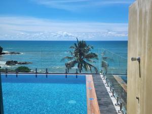 a swimming pool with a view of the ocean at Lavinia Bay Beach Hotel in Mount Lavinia