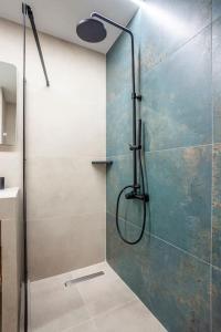 a shower with a glass door in a bathroom at FsN Central Lofts 303 /2bed / 5P in Thessaloniki +47 photos