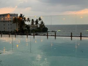 a swimming pool with a view of the ocean at Lavinia Bay Beach Hotel in Mount Lavinia