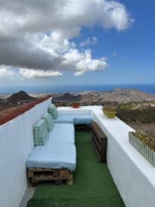 a balcony with beds and a view of the ocean at Casa Rural El Pasil 2 in Arona