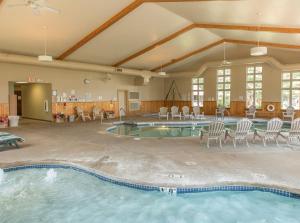 鷹河的住宿－野鷹旅館，一个带椅子和桌子的大型游泳池