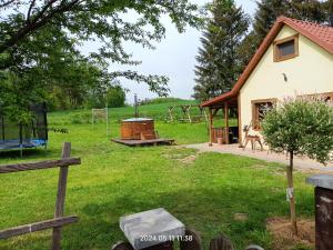 a yard with a house and a playground at Agroturystyka pod świerkami in Ryn