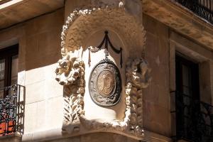 a clock on the side of a building at Casa Pince in Barcelona