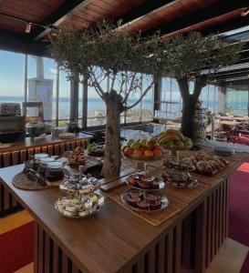 a buffet with food on a table with trees at Padam Hotel & SPA in Ulcinj