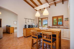 a kitchen with a wooden table and chairs at Buena Vista in Montuiri