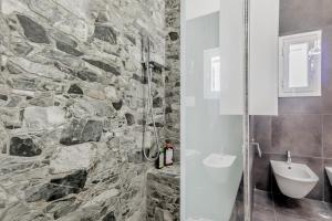 a stone bathroom with a shower and a toilet at Country Chic House in Castelnuovo di Porto +24 photos