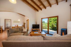 a living room with two couches and a tv at Buena Vista in Montuiri
