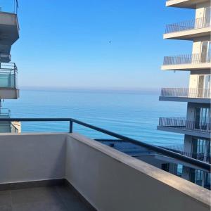 a view of the ocean from the balcony of a building at Rana Hedhun Apartment in Margjonaj