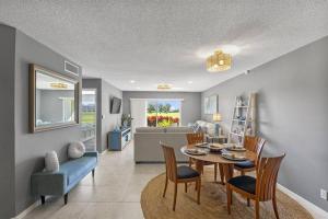a dining room and living room with a table and chairs at 2BD/2BA Condo w/ Beach Access & Pool Isla del Sol in St Petersburg