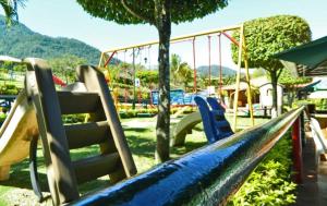 a park with a playground with a slide at Jarabacoa River Club & Resort in Jarabacoa