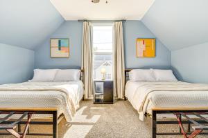 two beds in a room with blue walls at Home Near Downtown and Lucas Oil Stadium! in Indianapolis