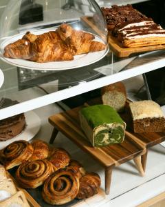 a display case with various types of bread and pastries at Casa Pince in Barcelona