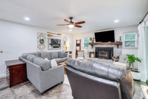 a living room with two couches and a fireplace at Beaver Lake Getaway with 2 Decks, Grill, and Views! in Garfield