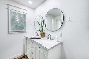 a white bathroom with a sink and a mirror at VIEWS! Lake Home w/ 2 Decks, Boat Parking & Peace in Garfield +22 photos