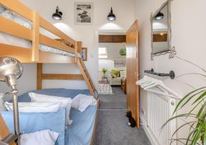 a room with two bunk beds and a hallway at Little Seacroft in Bucks Mills