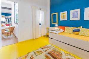 ein Schlafzimmer mit einem Bett und einer blauen Wand in der Unterkunft Tu estancia perfecta en Sevilla in Sevilla