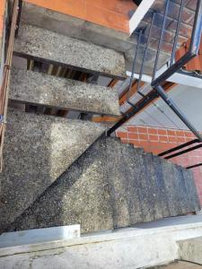 a set of concrete stairs with a metal railing at Maria minidepartamento Loja in Loja