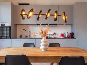 a kitchen with a wooden table with a vase on it at Apartment Mezzo by Interhome in Vercana