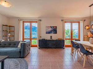 a living room with a couch and a table at Apartment Mezzo by Interhome in Vercana