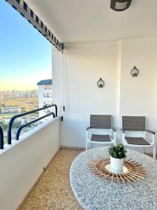 a balcony with a table and chairs on a building at Apartamento en primera línea de la playa a 15 minutos de la Ciudad de Valencia in Valencia