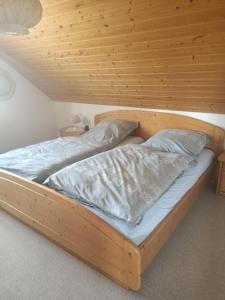a wooden bunk bed with two pillows on it at Schwarzwaldliebe in Grafenhausen