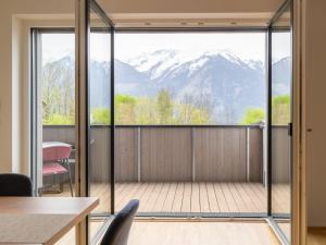 a room with a balcony with a view of mountains at Apartment be blue by Interhome in Mieming