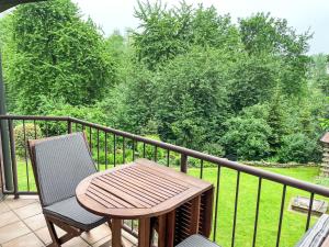 a wooden table and two chairs on a balcony at Apartment Kersten by Interhome in Essen
