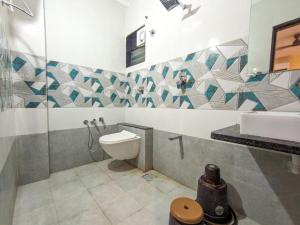 a bathroom with a toilet and a sink at Nirmal Luxury Rooms in Garudeshwar +38 photos