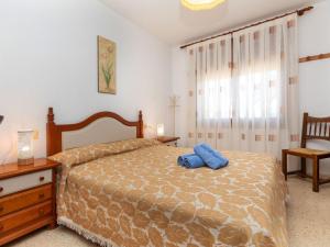 a bedroom with a bed with a blue towel on it at Holiday Home Villa Paloma by Interhome in Peñíscola