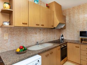 a kitchen with a sink and a bowl of fruit on the counter at Holiday Home Villa Paloma by Interhome in Peñíscola