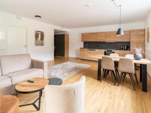 a living room and kitchen with a table and chairs at Apartment be magic by Interhome in Mieming