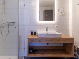 a bathroom with a sink and a shower at Apartment be magic by Interhome in Mieming +17 photos