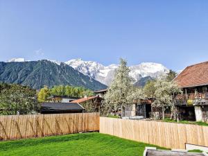 a backyard with a fence and mountains in the background at Apartment be magic by Interhome in Mieming
