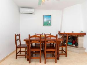 a dining room with a wooden table and chairs at Holiday Home Cristal by Interhome in Miami Platja +19 photos
