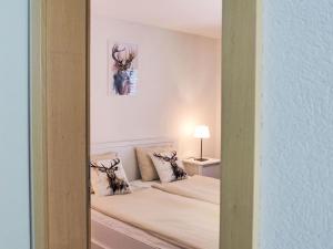 a bedroom with a bed with pillows on it at Apartment Bergluft by Interhome in Kandersteg