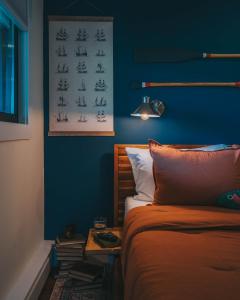 1 dormitorio con cama y pared azul en Willow Pond Motel, en Catskill