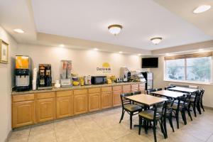 a restaurant with two tables and a kitchen with a counter at Days Inn by Wyndham Clearfield in Clearfield