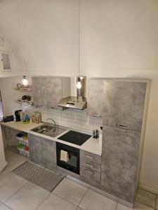 a kitchen with a sink and a stove at CASA DI MAGGIE in Sanremo