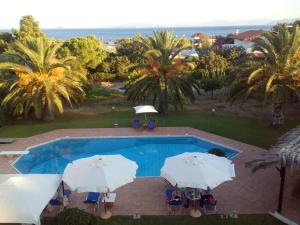 an image of a swimming pool with umbrellas at Kinetious Nisous Stylish Apt, Pool, near the Beach in Kineta +23 photos