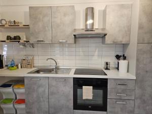 a kitchen with a sink and a stove at Casa di MAGGIE in Sanremo +11 photos