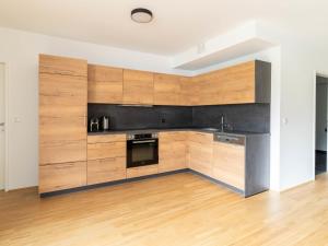 a kitchen with wooden cabinets and a stove at Apartment be calm by Interhome in Mieming
